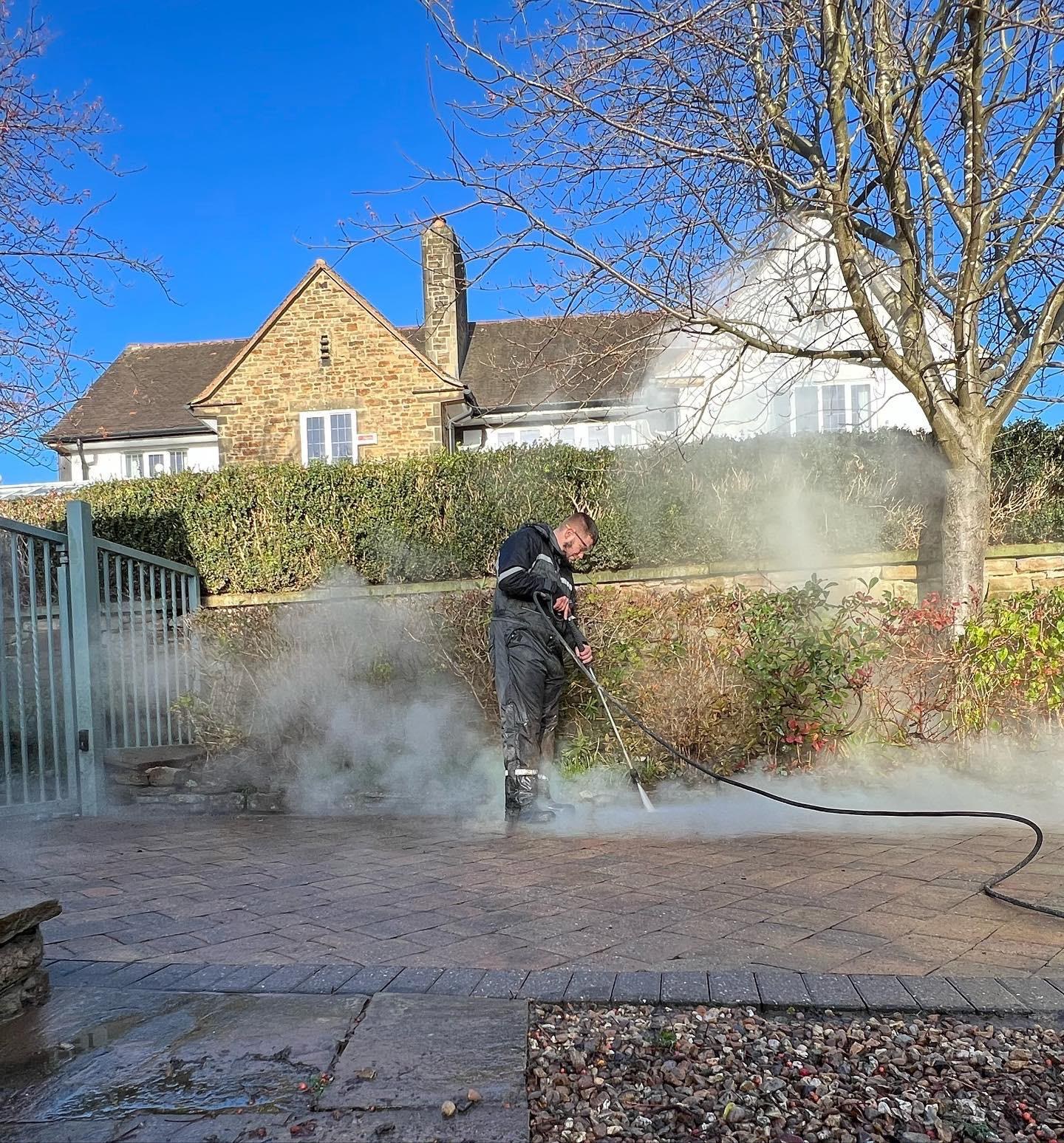 Patio pressure washing lifting years of dirt and grime from the block paving